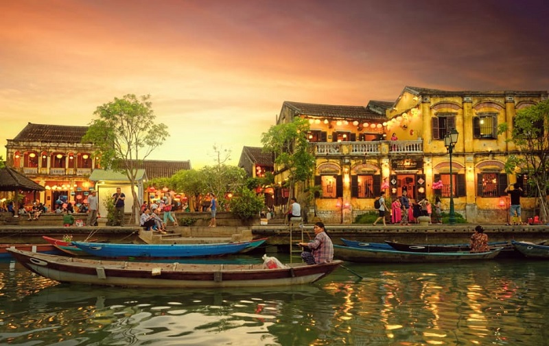 Hoi An riverside view with boats and lanterns
