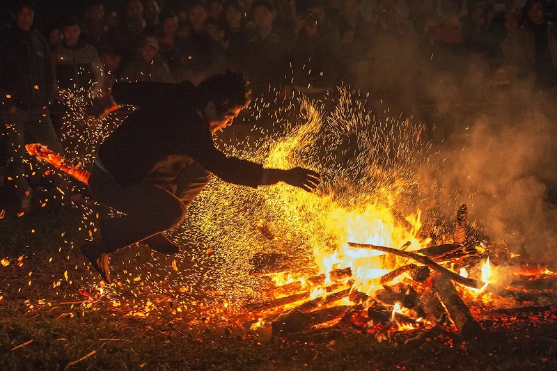 Pa Then men jumping over flames during the Fire Jumping Festival in Ha Giang