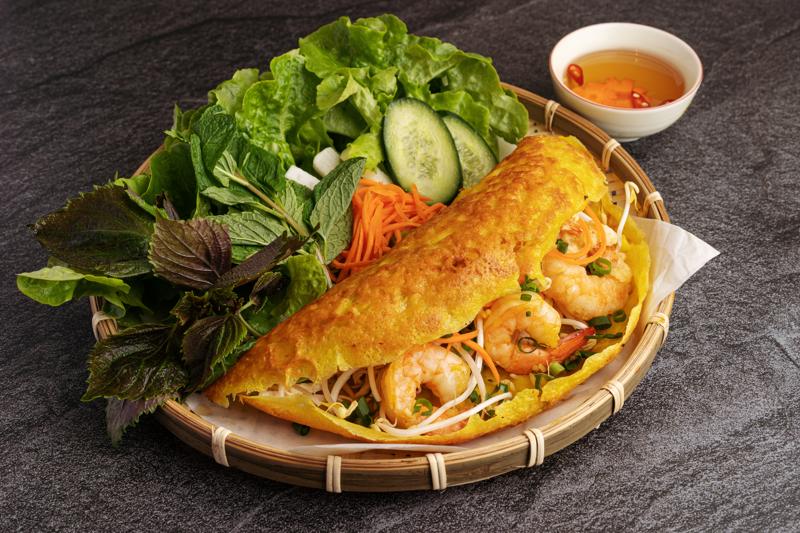 Crispy Banh Xeo with fresh herbs and fish sauce