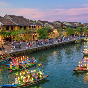 Colorful lanterns and old buildings along the river in Hoi An Ancient Town.