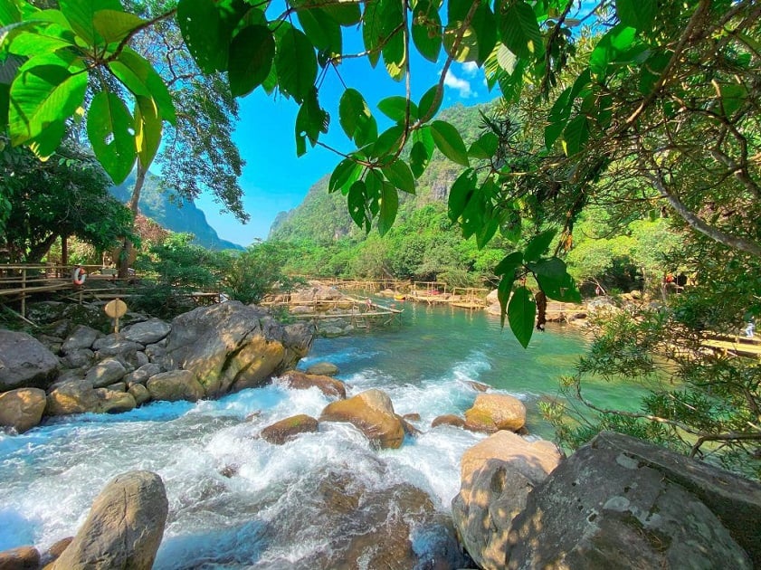 Mooc Spring emerald river surrounded by lush forest