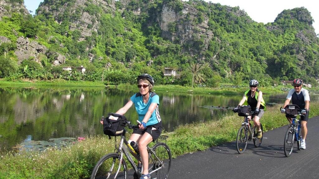 Cycling through rice fields in Tam Coc, Ninh Binh