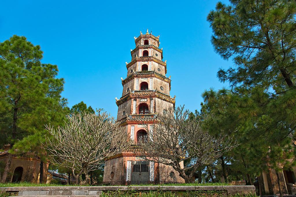 Thien Mu Pagoda with its seven-story tower surrounded by pine trees in Hue