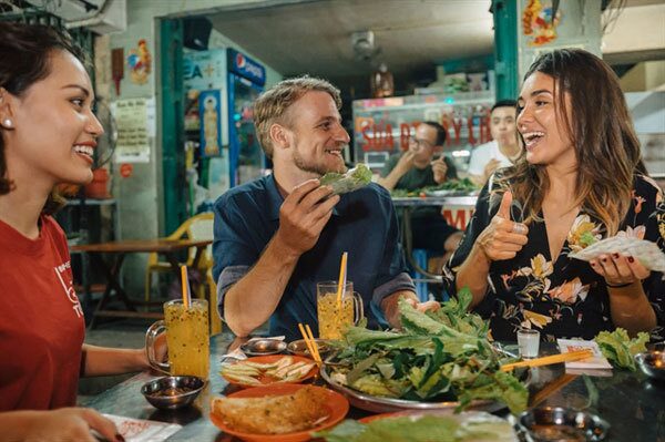 Couple enjoying authentic Vietnamese street food during a foodie-themed holiday with Maverick Journeys