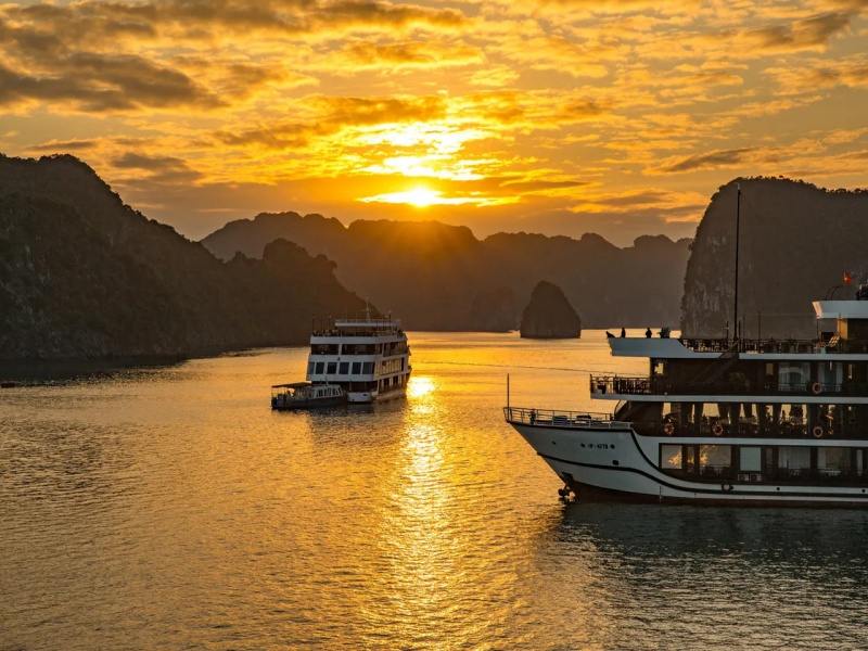 Overnight cruise ship sailing through Ha Long Bay limestone islands