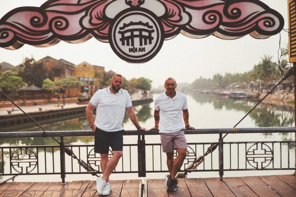 Same-sex couple traveling in Vietnam in a romantic old town street