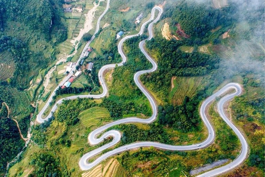 Ha Giang Loop mountain road with dramatic landscapes and deep valleys
