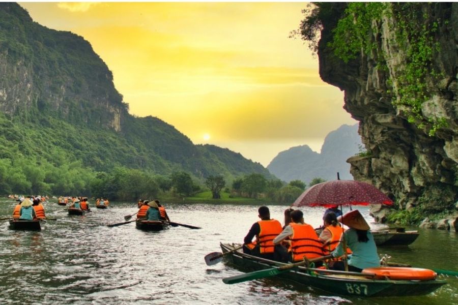 Ninh Binh limestone landscape with boat ride through rivers and rice fields