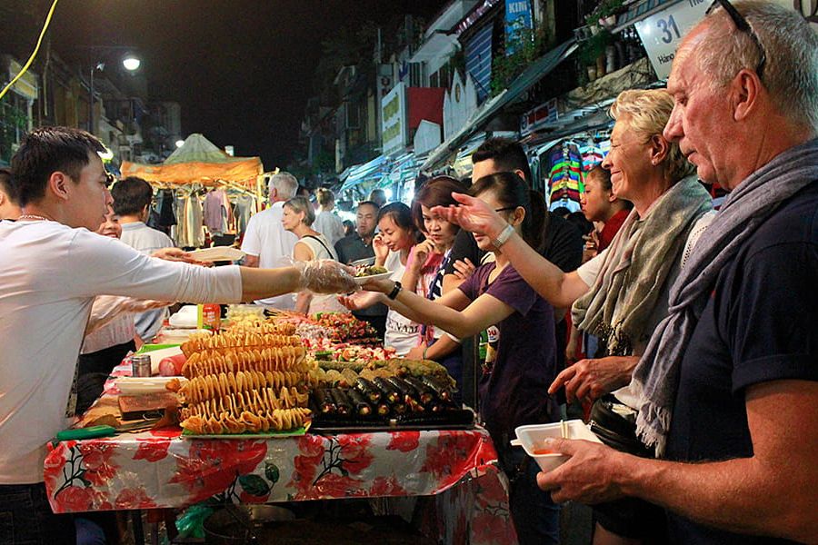 A golden rice flour pancake served with herbs and dipping sauce.