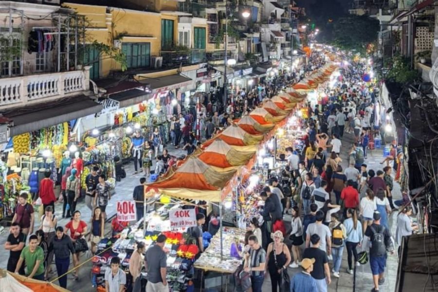 Visitors exploring Hanoi Weekend Night Market in the Old Quarter