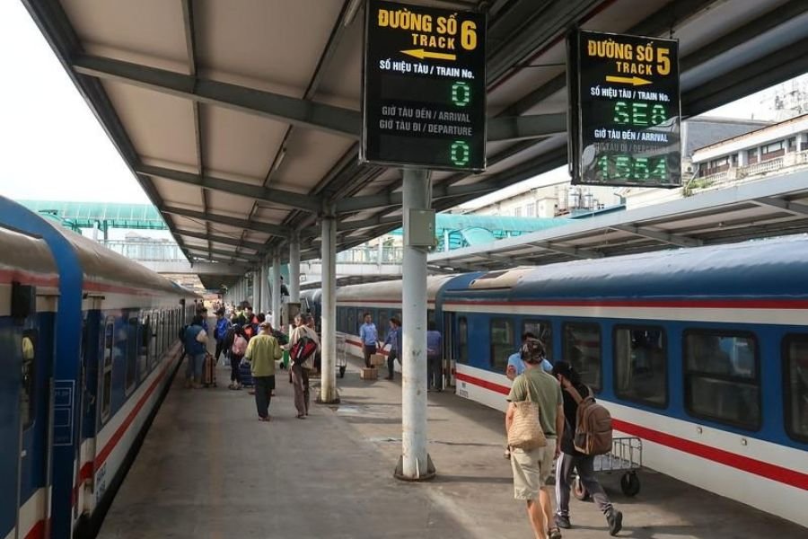 Travelers boarding a train at a railway station in Vietnam