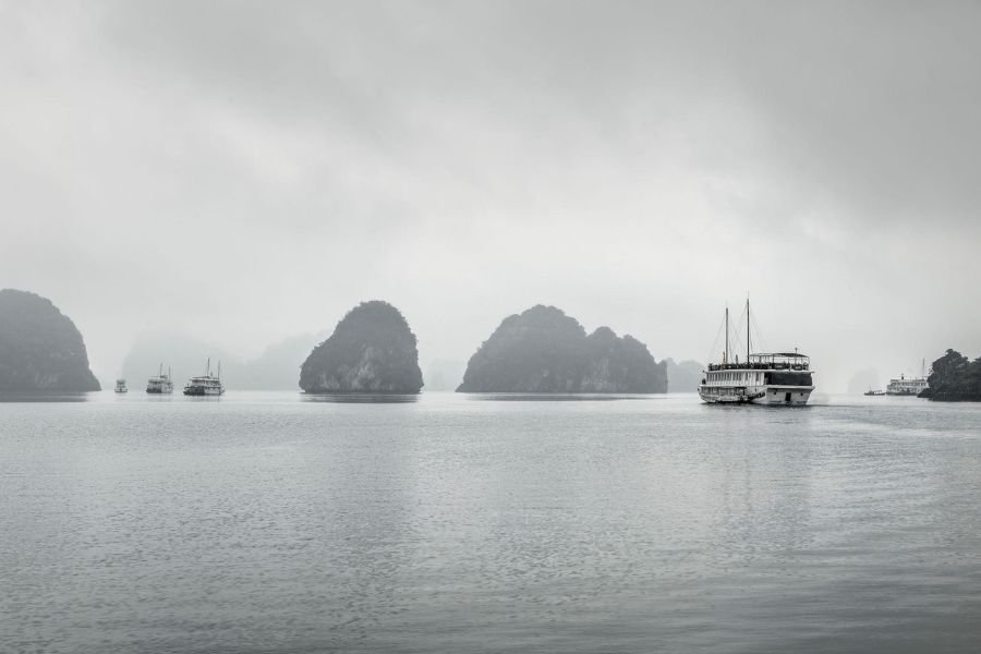 Cloudy weather over Ha Long Bay with limestone islands and misty skies