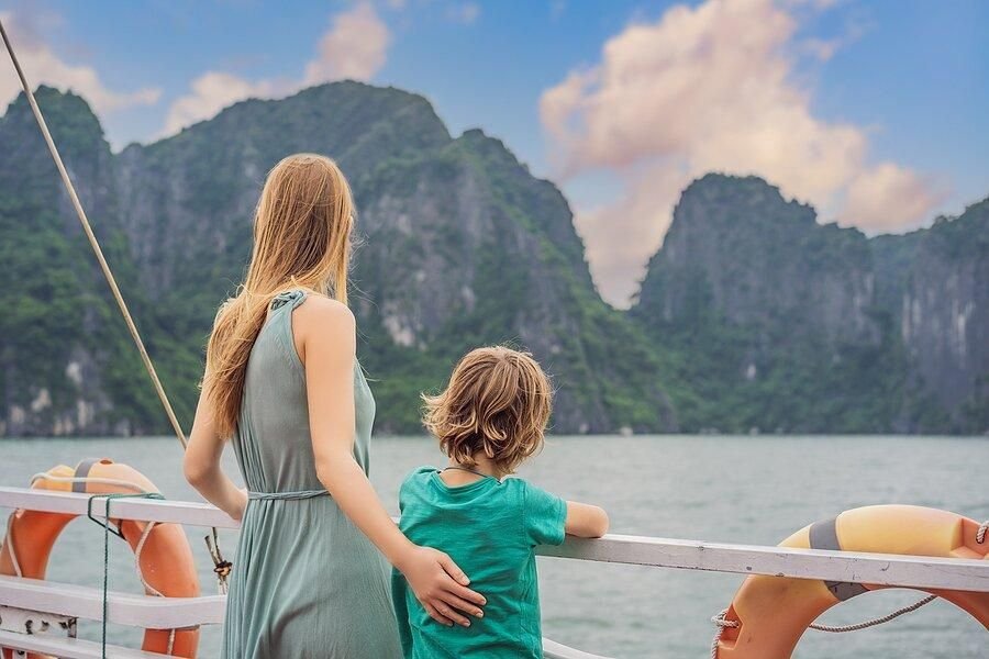 Family enjoying a sightseeing cruise in Ha Long Bay Vietnam