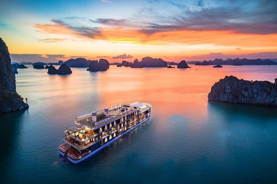 Overnight cruise boat anchored among limestone islands in Ha Long Bay Vietnam